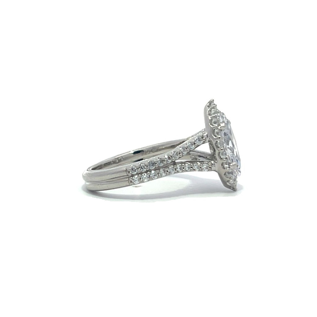 Silver pear-shaped diamond engagement ring with a halo setting and split shank on a white background.