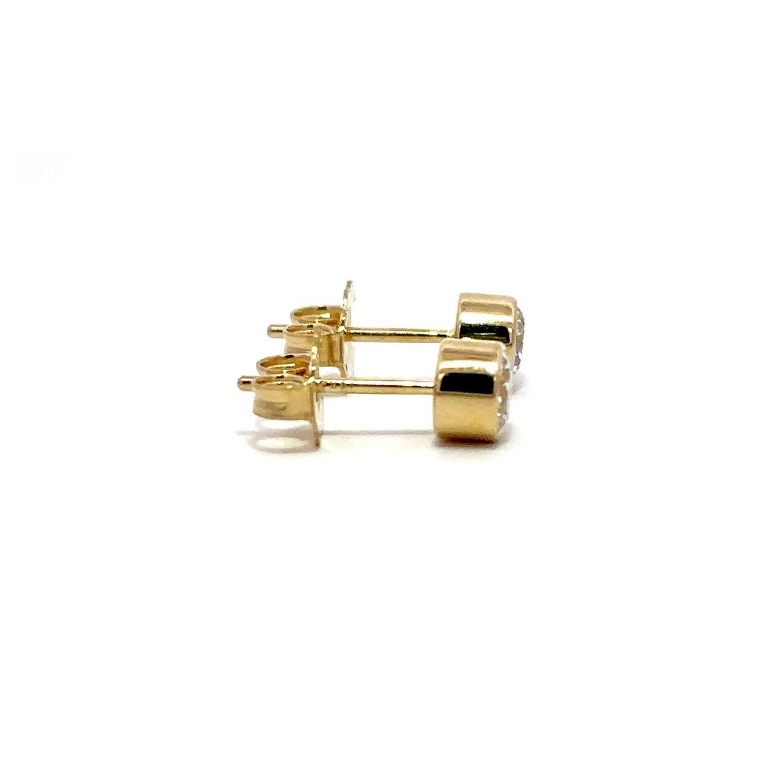 Yellow gold diamond stud earrings on a white background