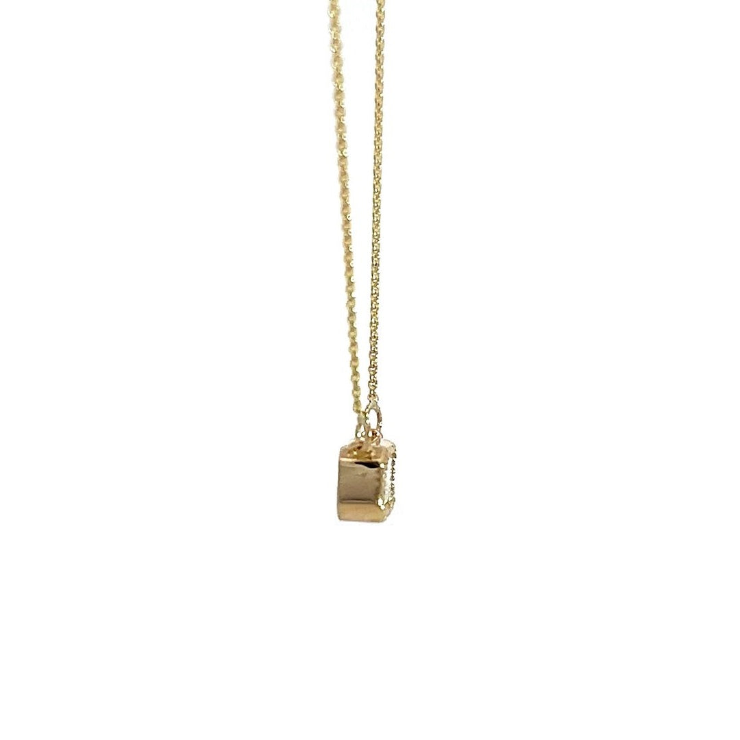 Yellow gold necklace with an emerald-cut diamond pendant on a white background.