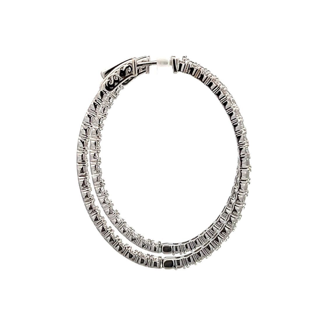 White gold diamond hoop earrings on a white background.