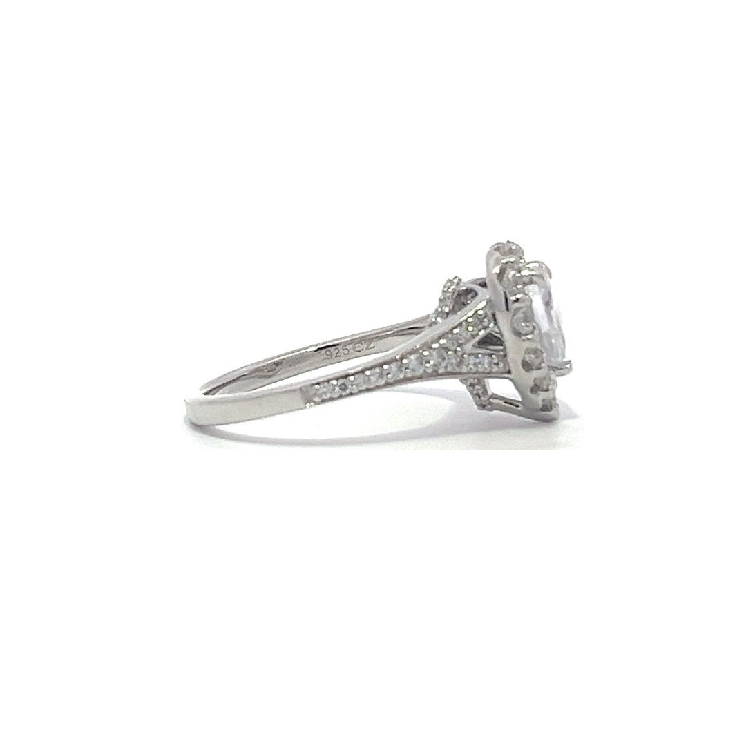 Silver heart-shaped diamond engagement ring with a halo setting and split shank on a white background.