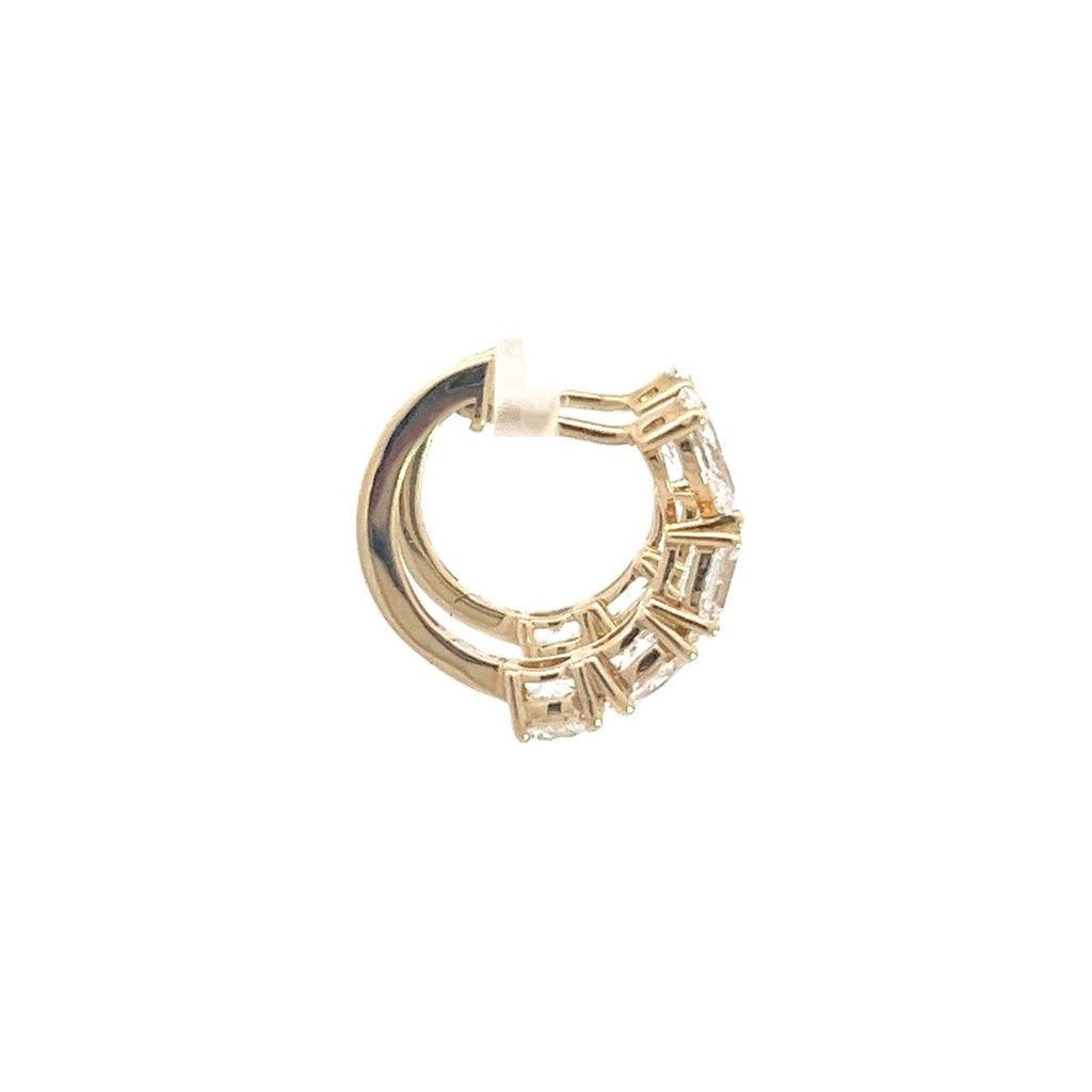 Yellow gold hoop earrings with multiple diamond accents, including round and baguette cuts, on a white background.