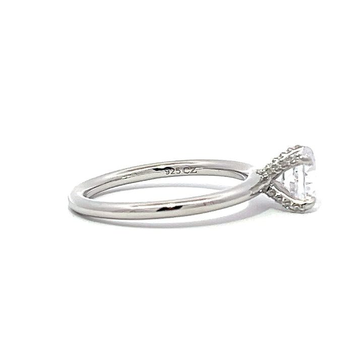 White gold diamond engagement ring with a twisted band on a white background.