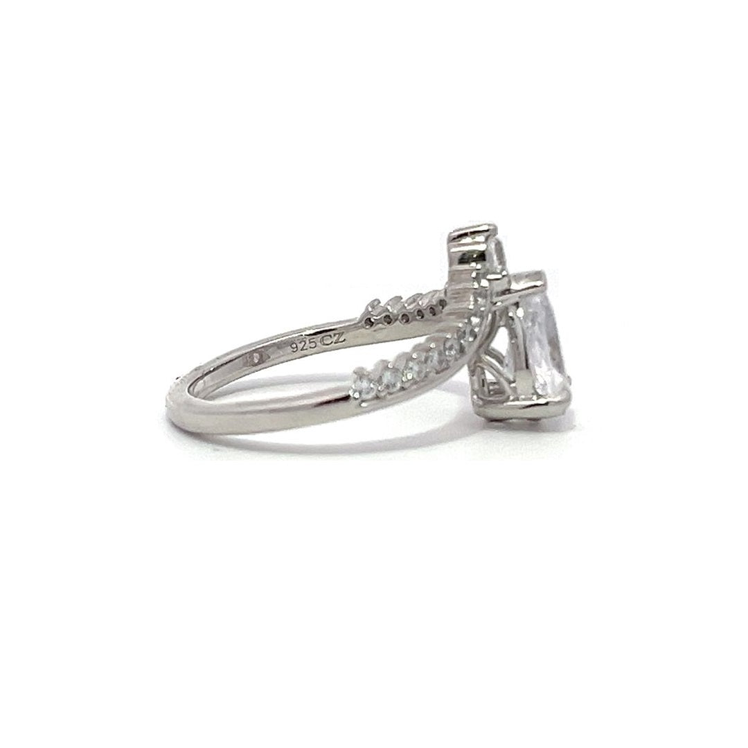 White gold pear-shaped diamond engagement ring with a diamond band on a white background