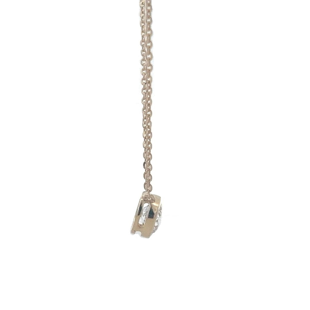 Yellow gold necklace with a round diamond solitaire pendant on a white background.