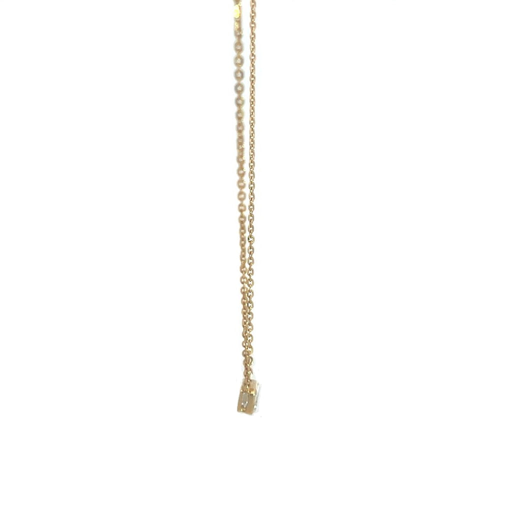 Yellow gold necklace with an emerald-cut diamond pendant on a white background.