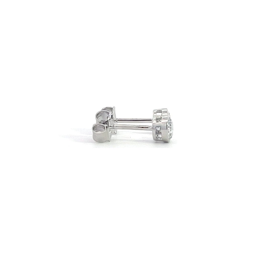 White gold stud earrings with round diamonds in  bezel setting on a white background.