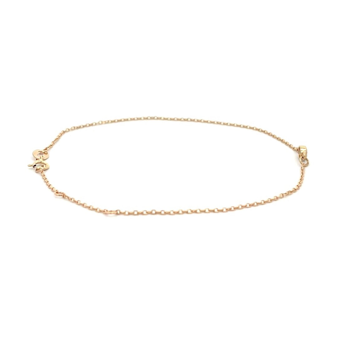 Yellow gold bracelet with a single diamond on a white background.