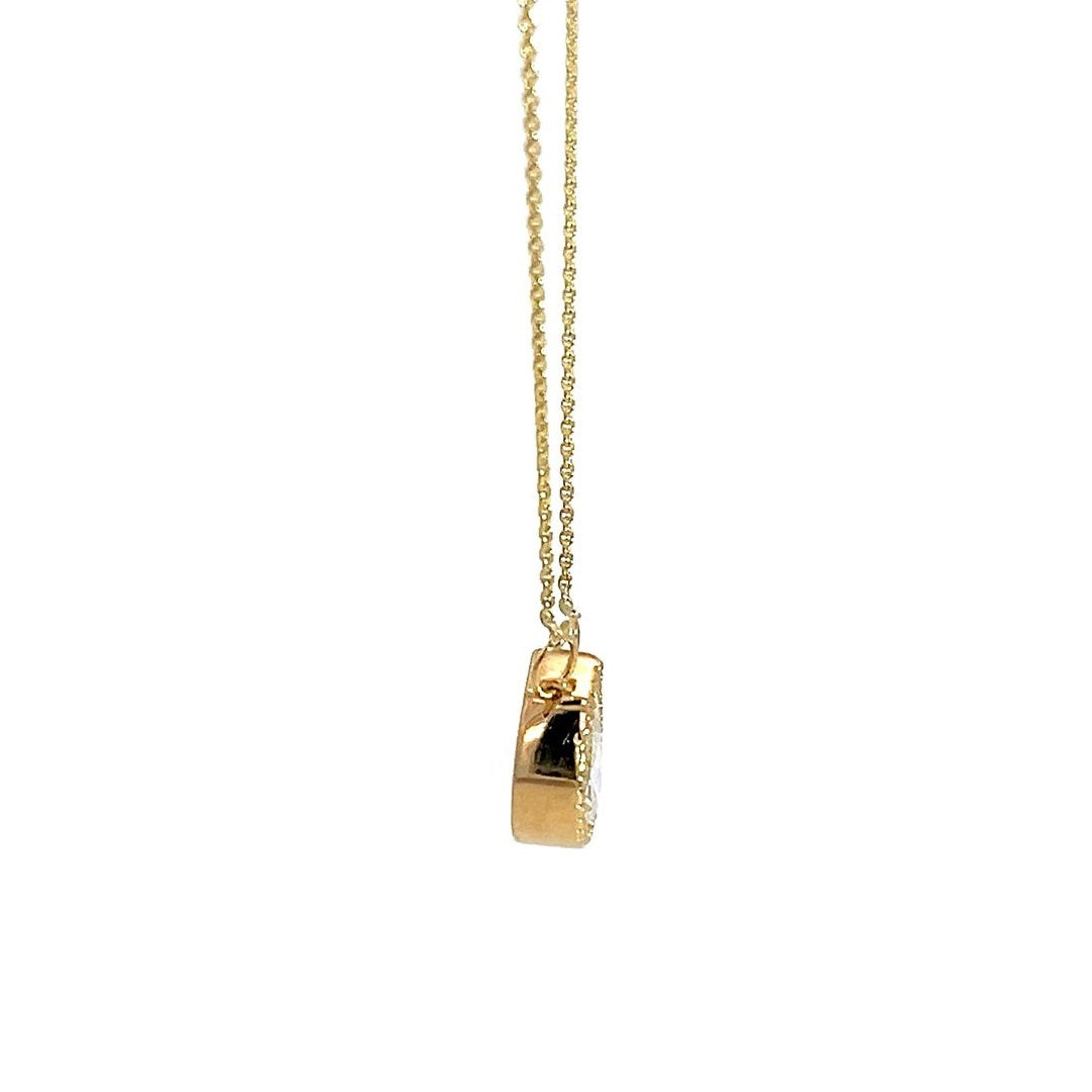 Yellow gold necklace with an oval-shaped diamond pendant on a white background.