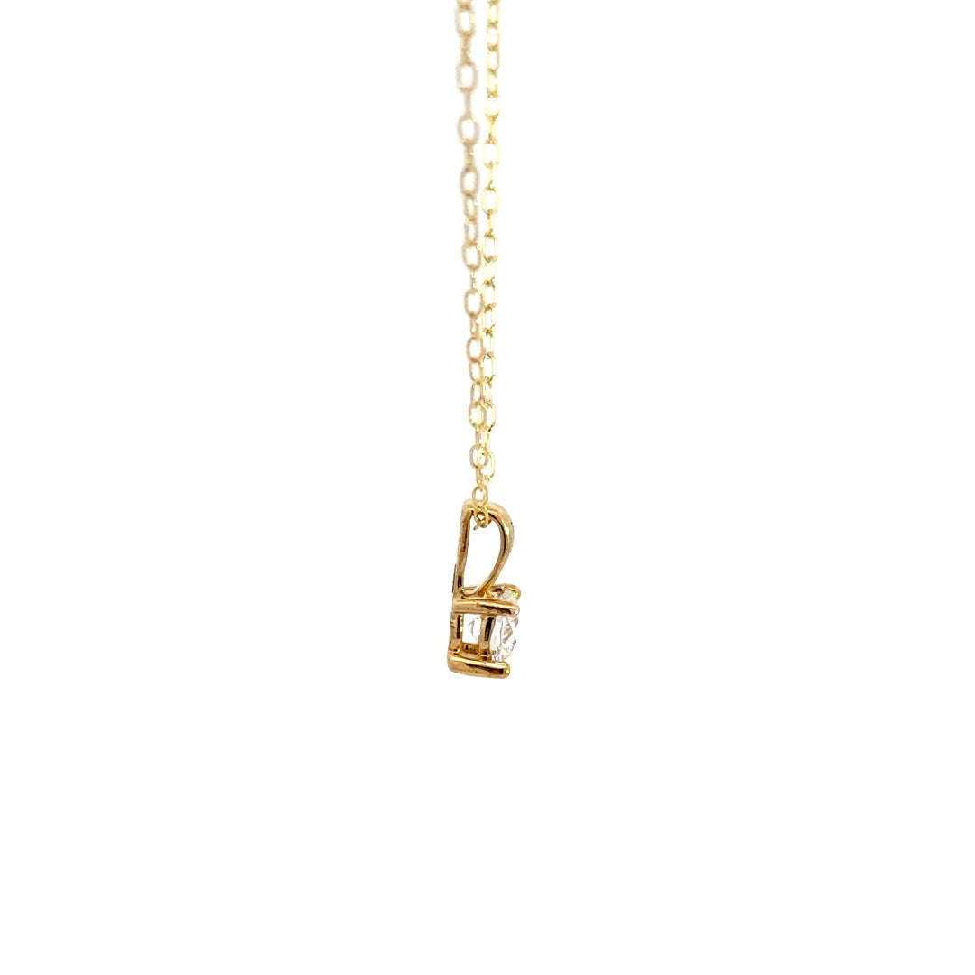 Yellow gold diamond solitaire necklace on a white background.