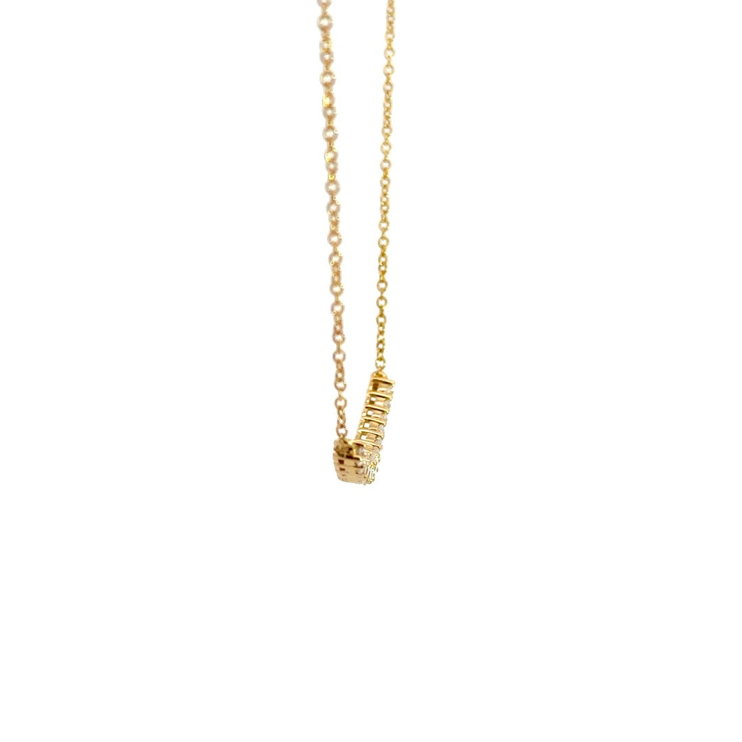 Yellow gold diamond necklace on a white background