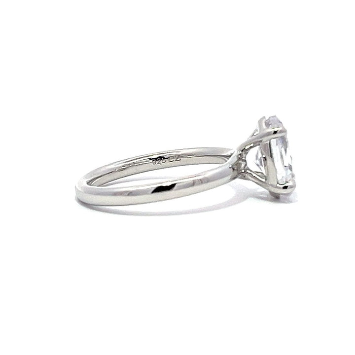 White gold oval diamond solitaire engagement ring on a white background.