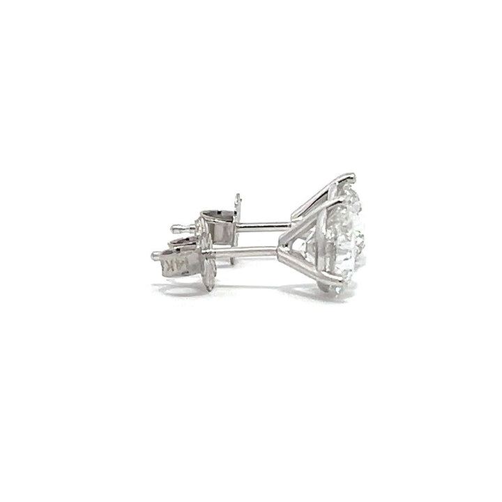 White gold stud earrings with round diamonds on a white background.