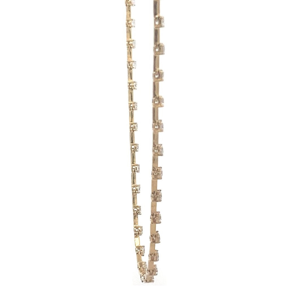 Yellow gold necklace with a row of round diamonds on a white background.