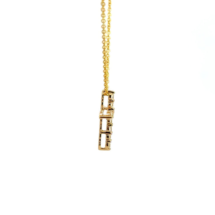 Yellow gold diamond cross necklace on a white background