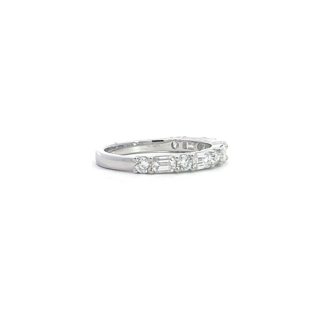 SIlver eternity band with alternating round and baguette-cut diamonds, on a white background.