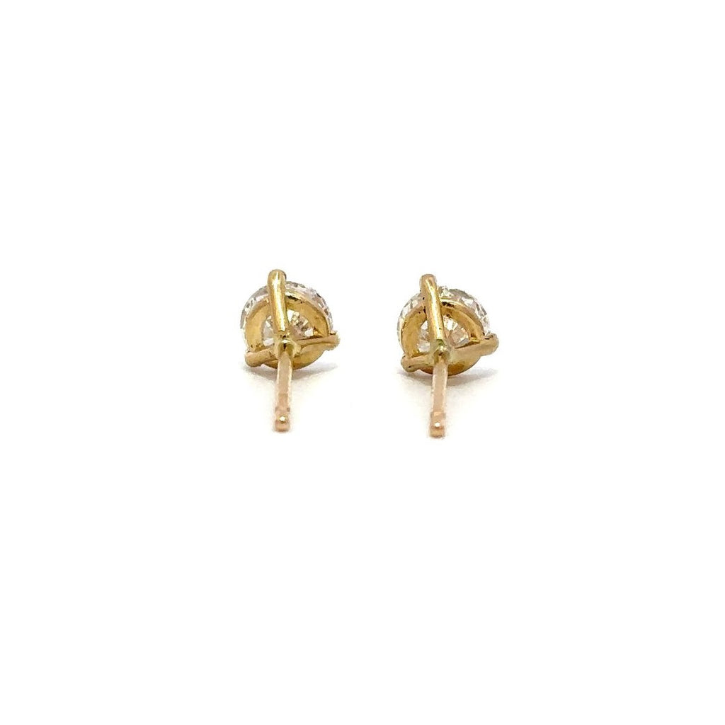 Pair of yellow gold stud earrings with a prong setting of diamonds on a white background.