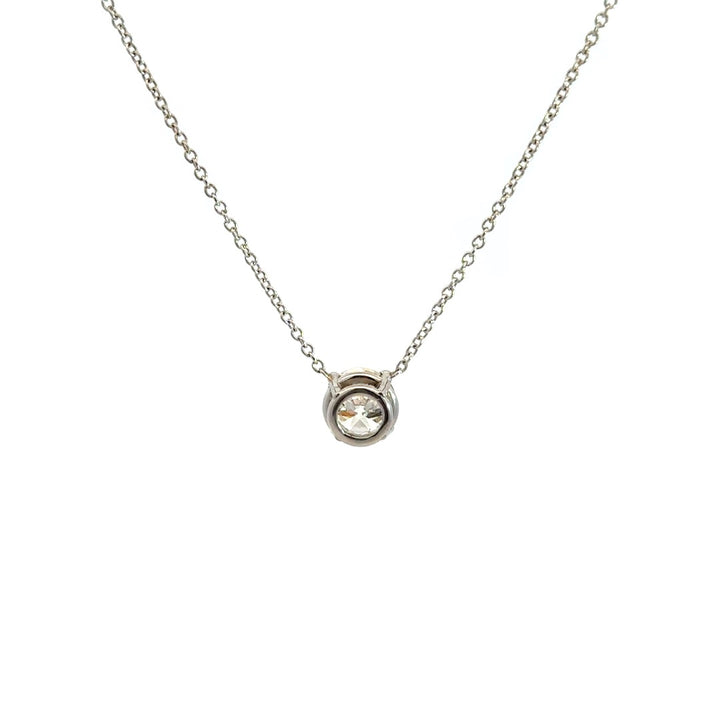 Diamond solitaire necklace on a white background.