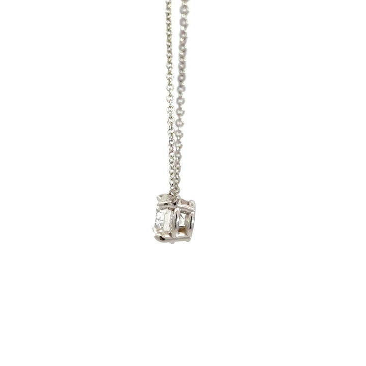 Diamond solitaire necklace on a white background.