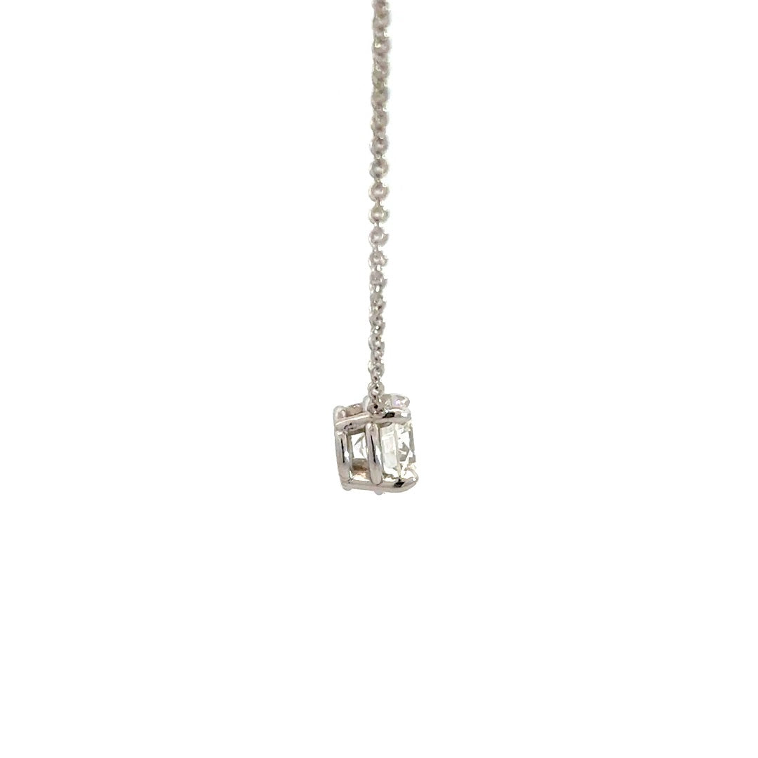 Diamond solitaire necklace on a white background.