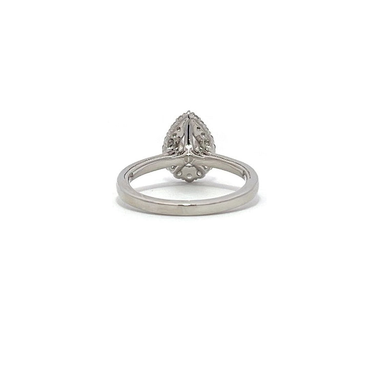 White gold pear-shaped diamond engagement ring with a halo setting on a white background