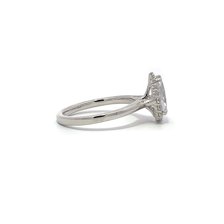 White gold pear-shaped diamond engagement ring with a halo setting on a white background