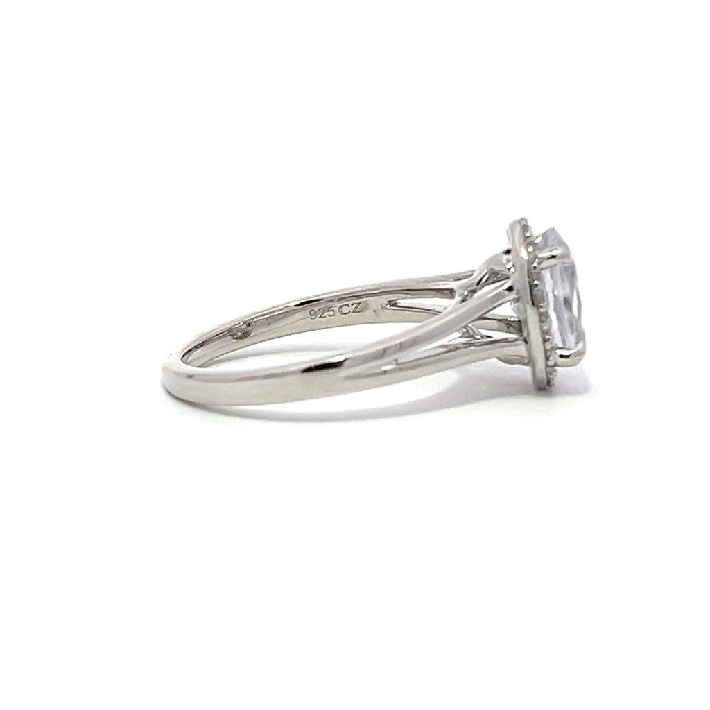 White gold oval diamond engagement ring with a halo setting and split shank on a white background