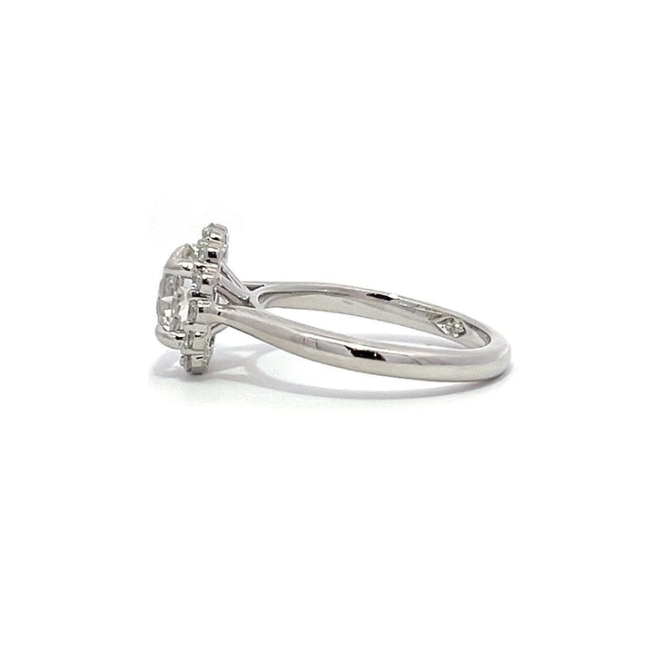 White gold diamond engagement ring with a halo setting on a white background.