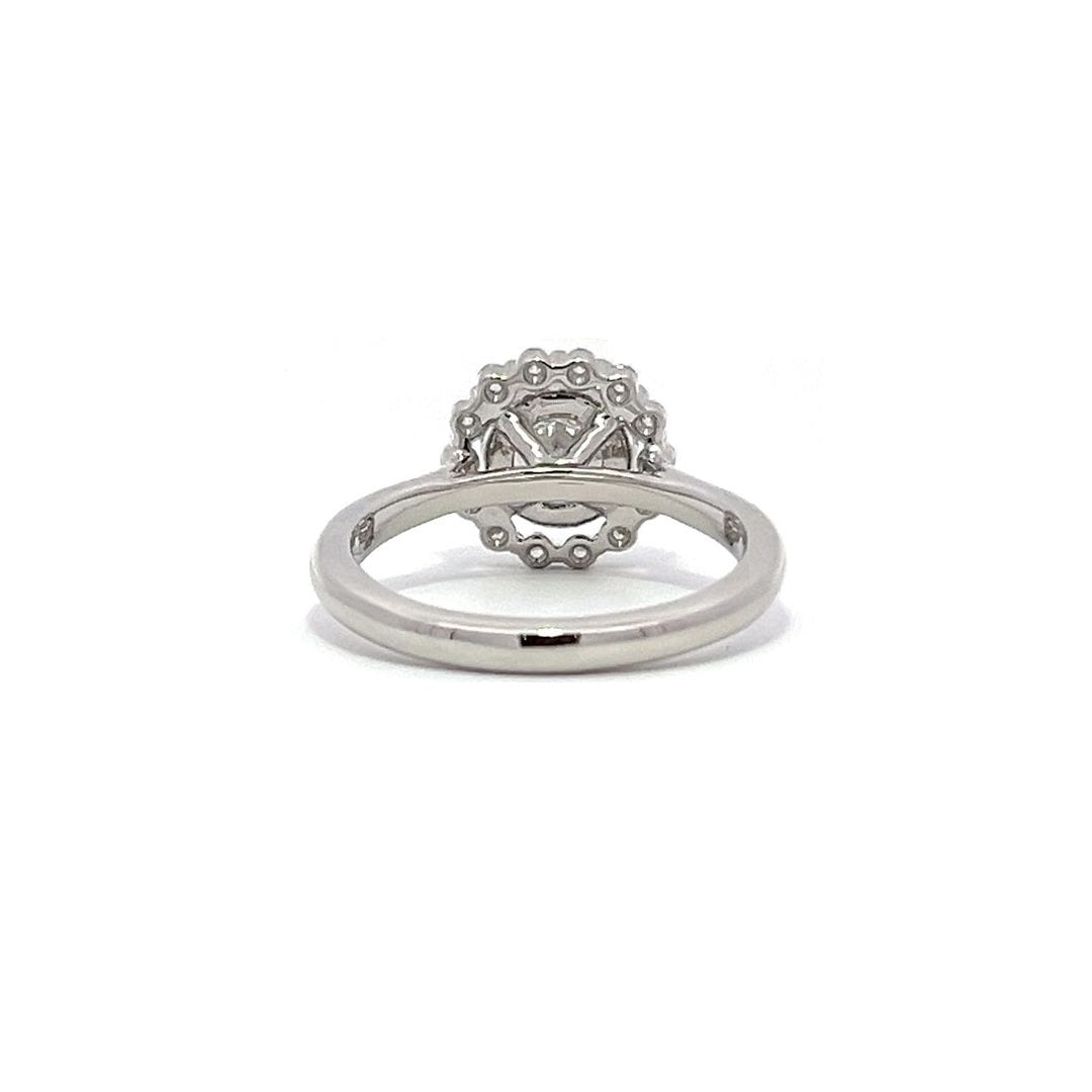 White gold diamond engagement ring with a halo setting on a white background.