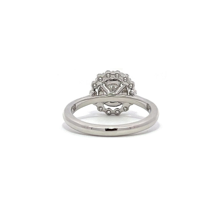 White gold diamond engagement ring with a halo setting on a white background.