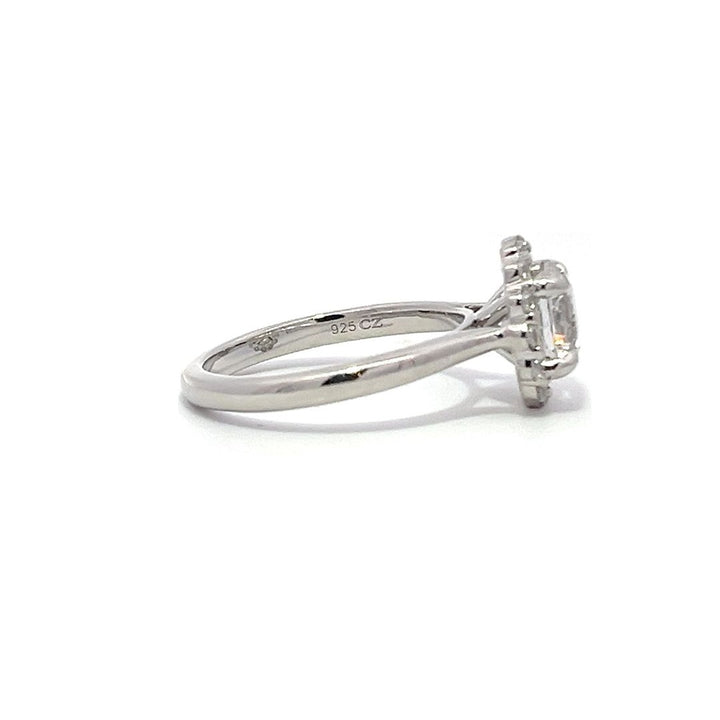 White gold diamond engagement ring with a halo setting on a white background.