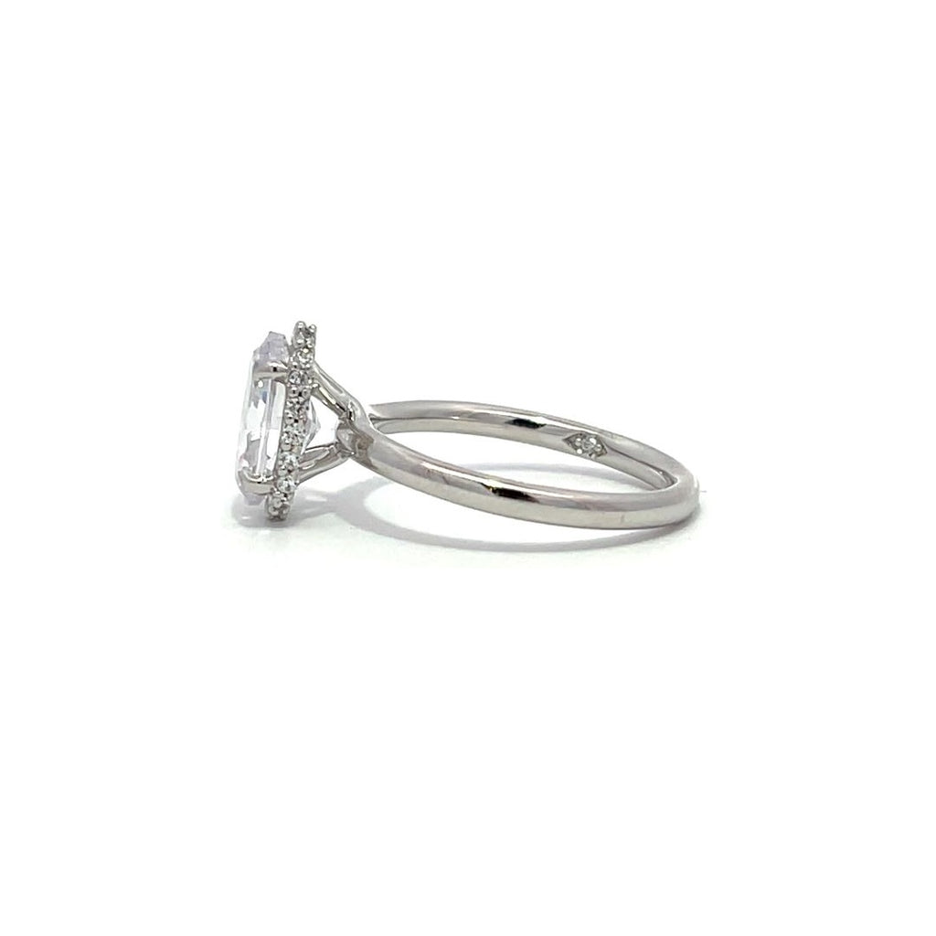 White gold diamond engagement ring with a halo setting and a split shank on a white background.