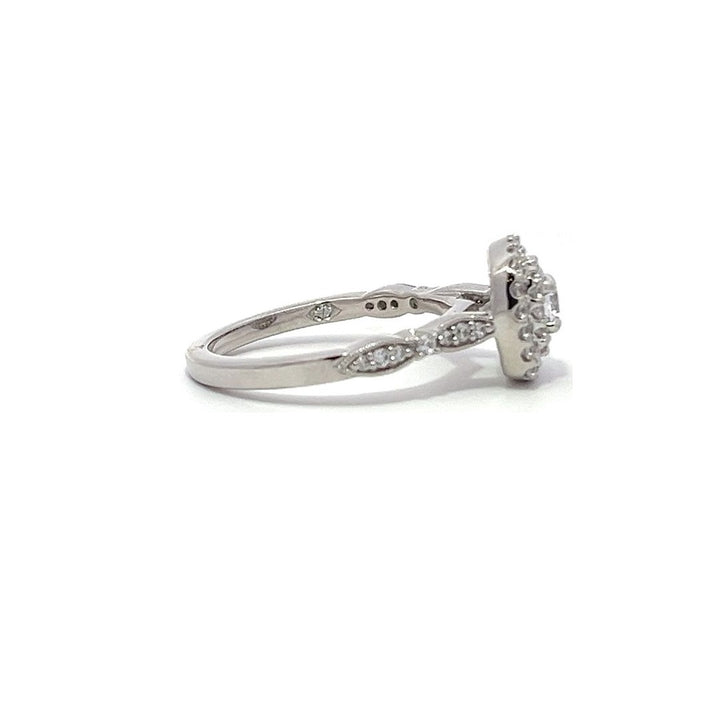 White gold diamond engagement ring with a double halo setting on a white background.