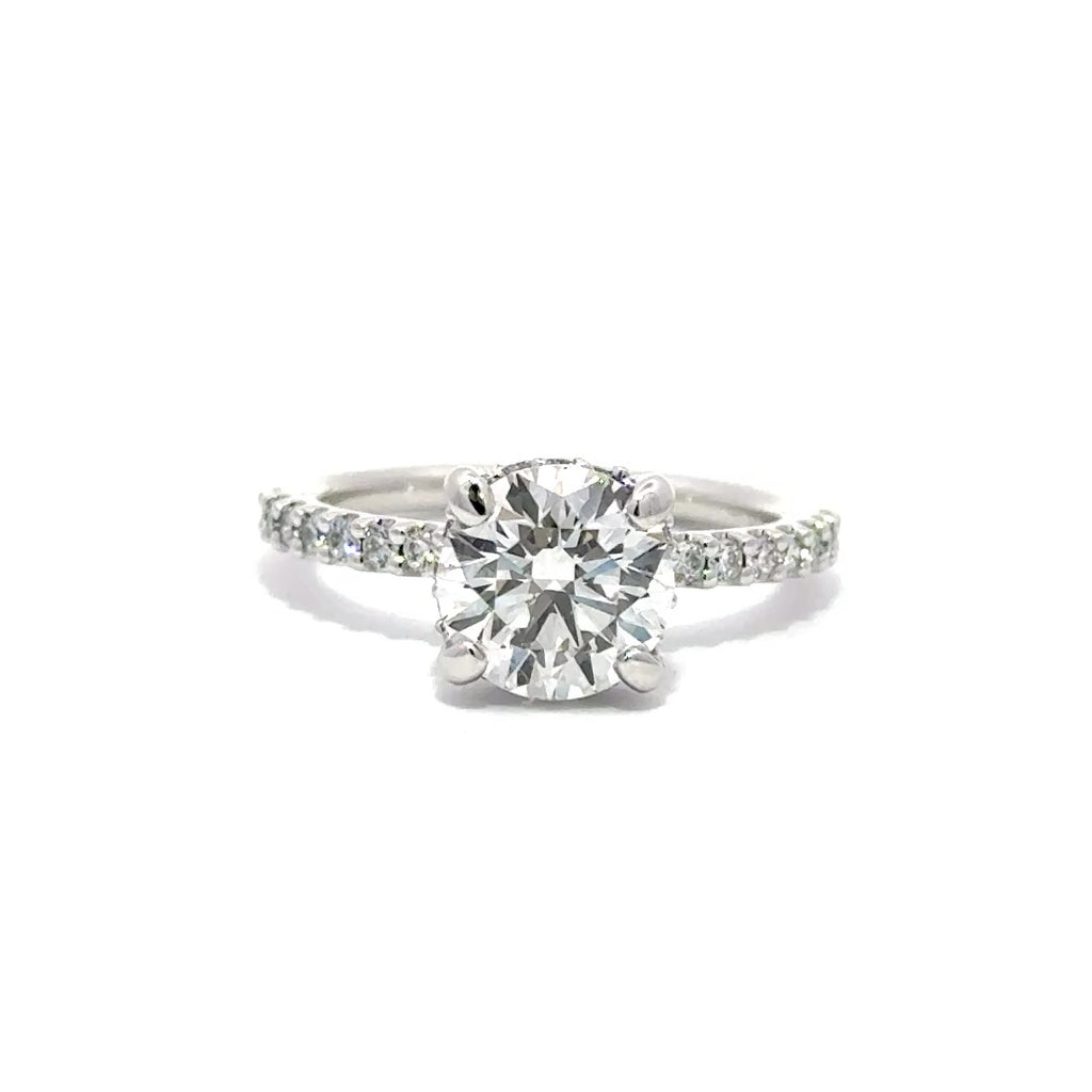 Front view of silver engagement ring with a center round cut diamond.