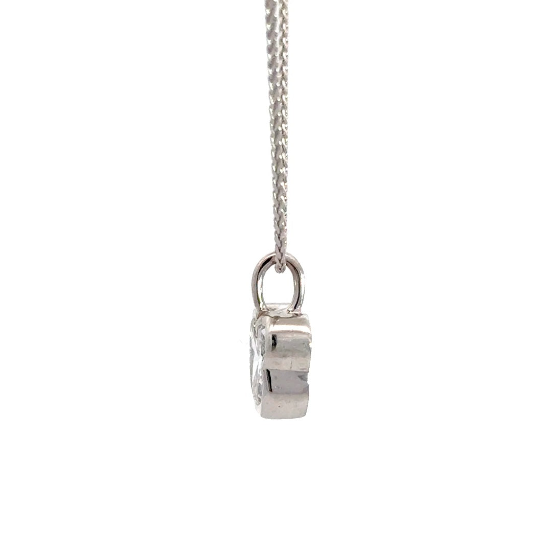 Side view of silver necklace with a diamond pendant shaped like a Mickey Mouse head  in a bezel setting