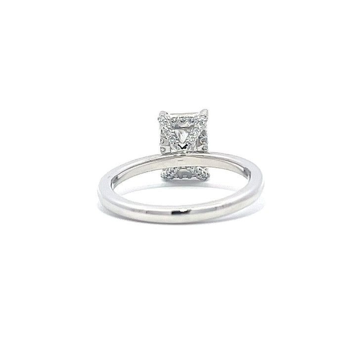 White gold engagement ring with a radiant-cut diamond center stone on a white background.