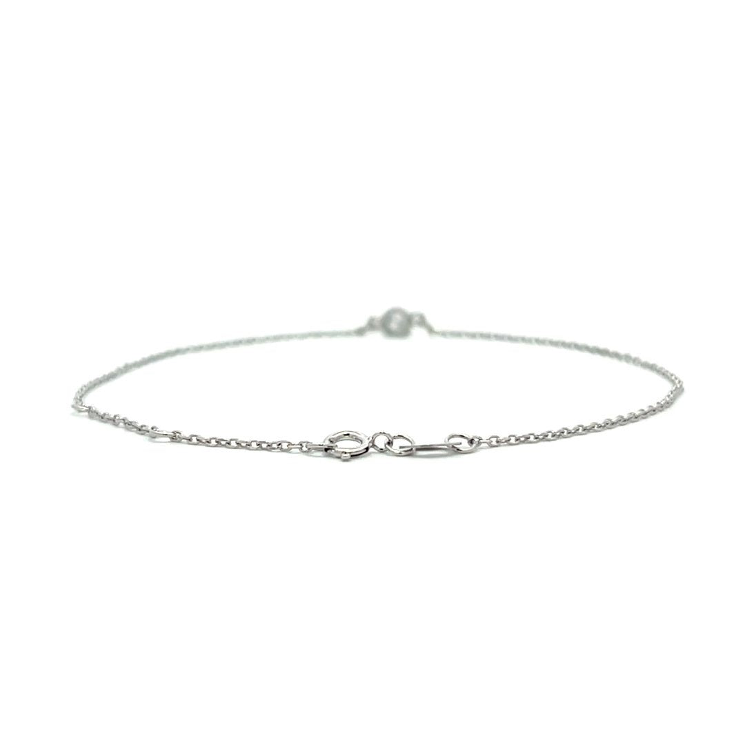 Silver bracelet with a single diamond pendant on a white background.