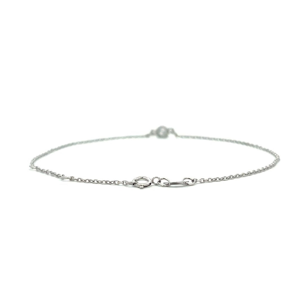 Silver bracelet with a single diamond pendant on a white background.