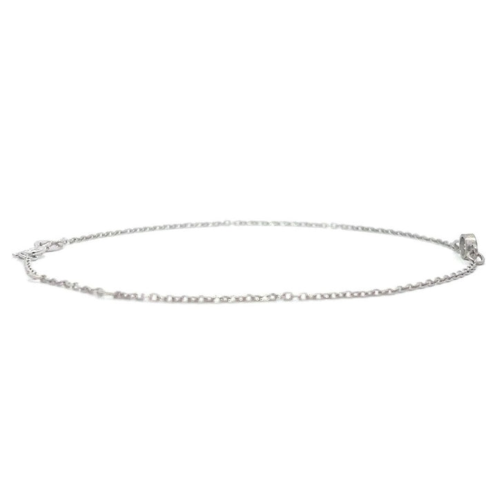 Silver bracelet with a single diamond pendant on a white background.