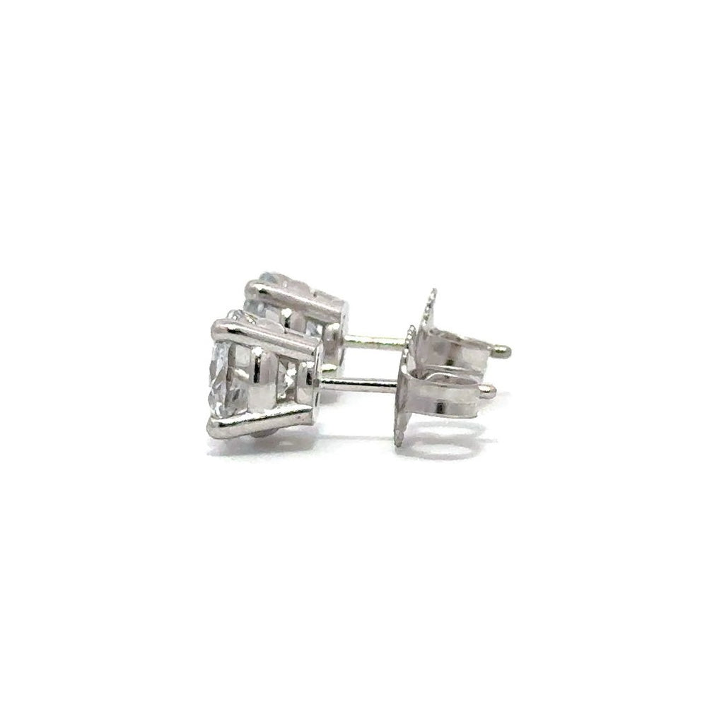 Pair of silver stud diamond earrings on a white background