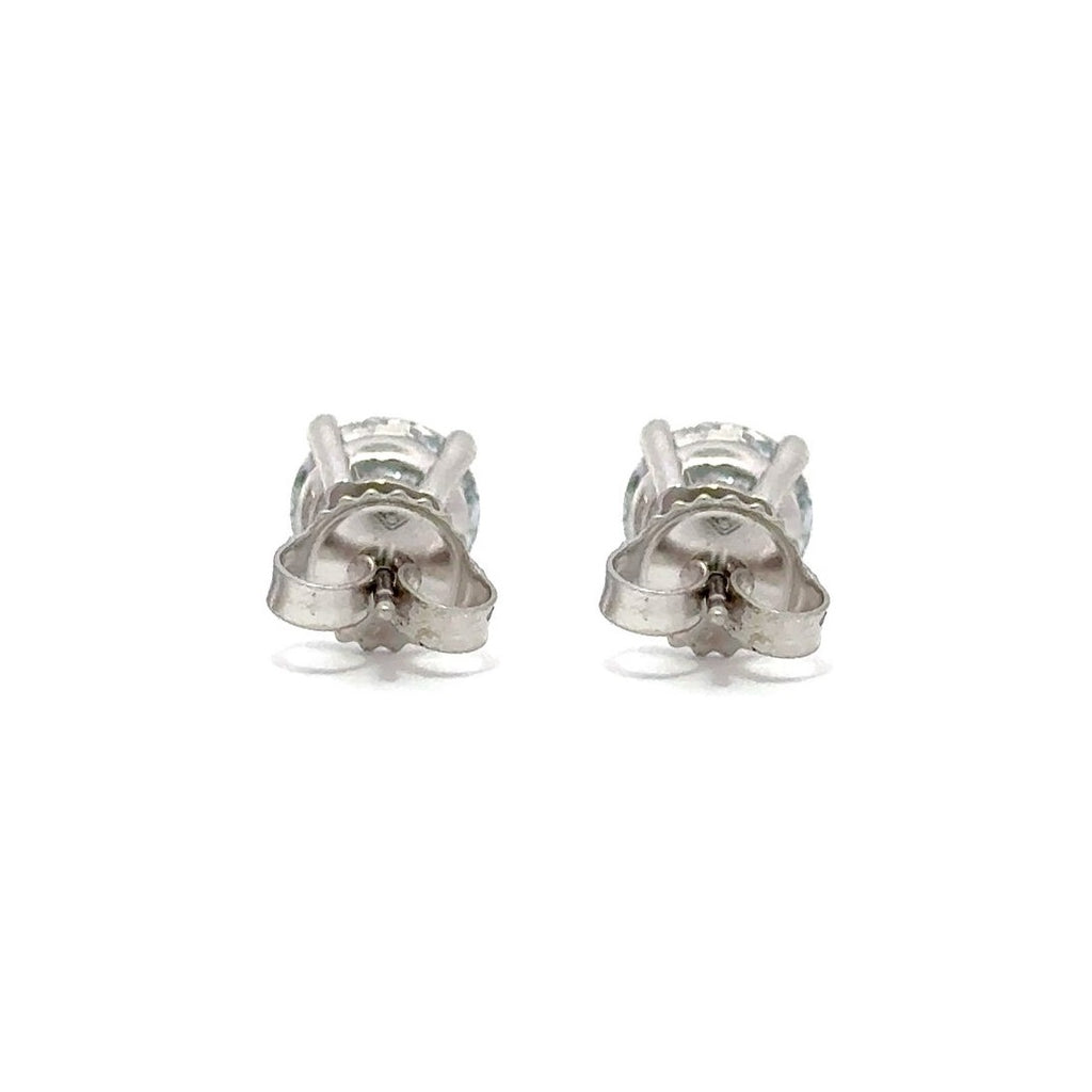 Pair of silver stud diamond earrings on a white background