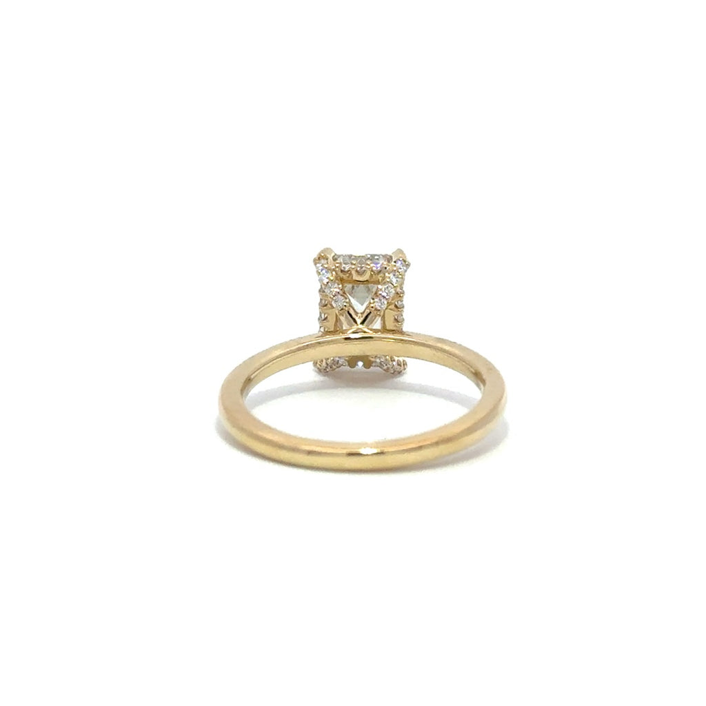 Back view of yellow gold engagement ring with a center emerald cut diamond.