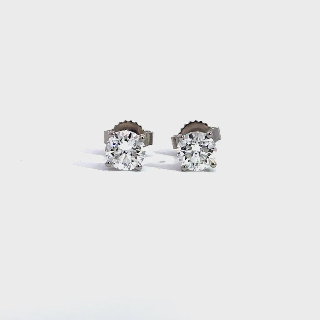 Silver stud earrings in a white background