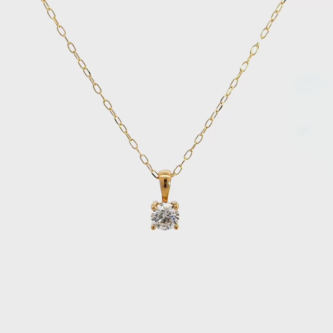 Yellow gold diamond solitaire necklace on a white background.