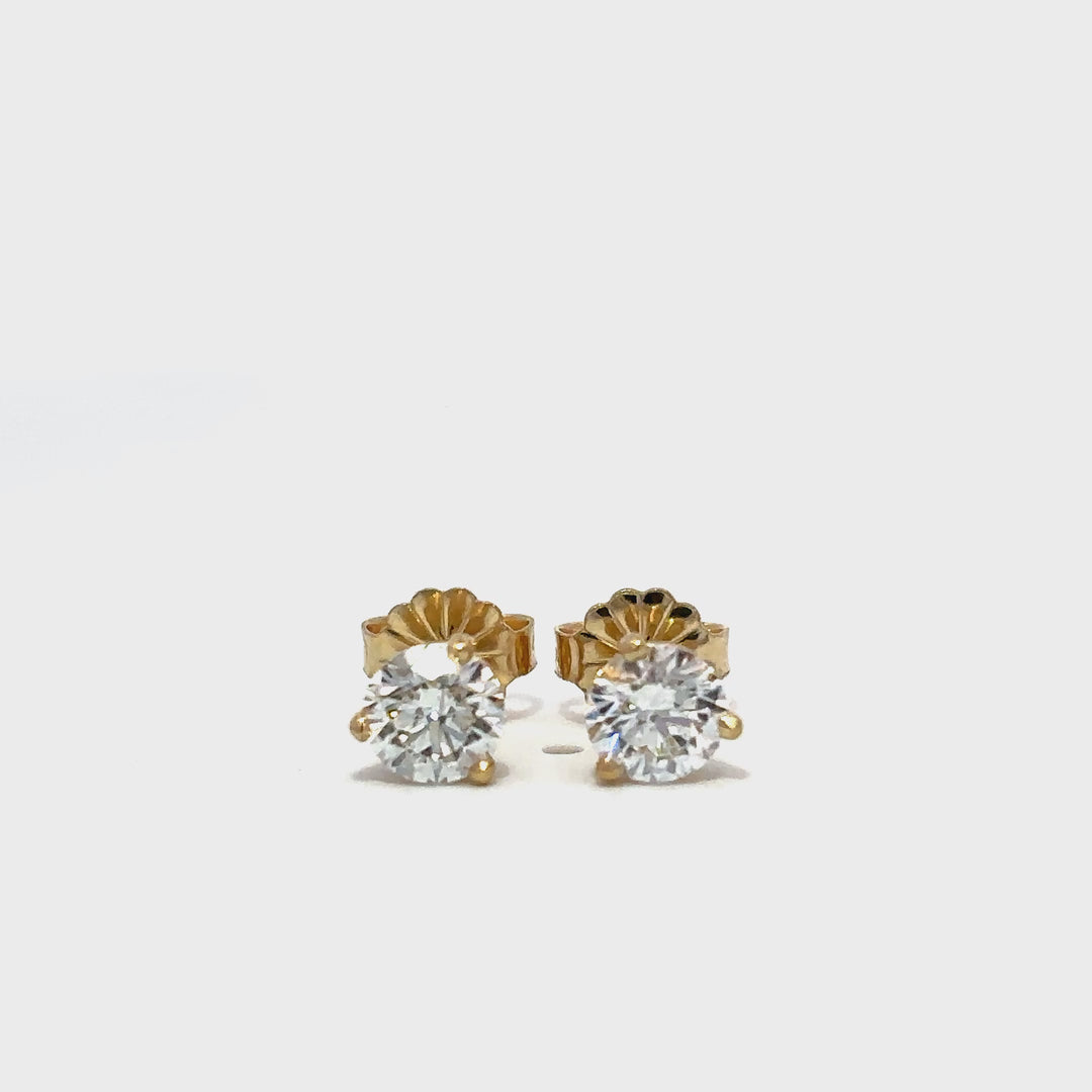 Yellow gold diamond stud earrings on a white background.*