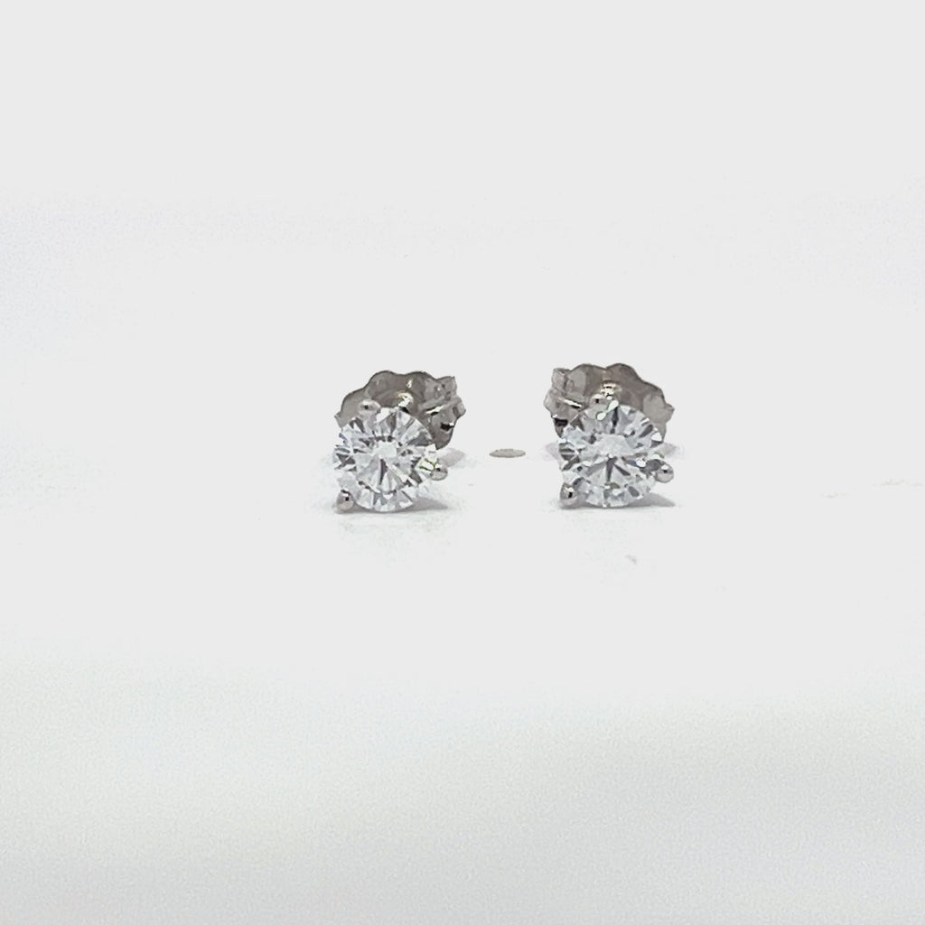 White gold stud earrings with round diamonds on a white background.