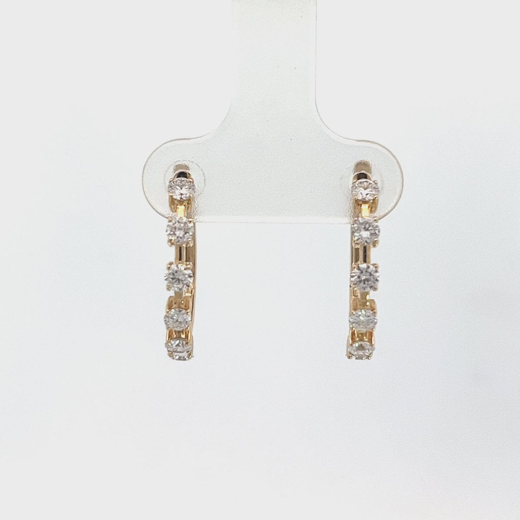 Yellow gold hoop earrings with five diamond accents on a white background.