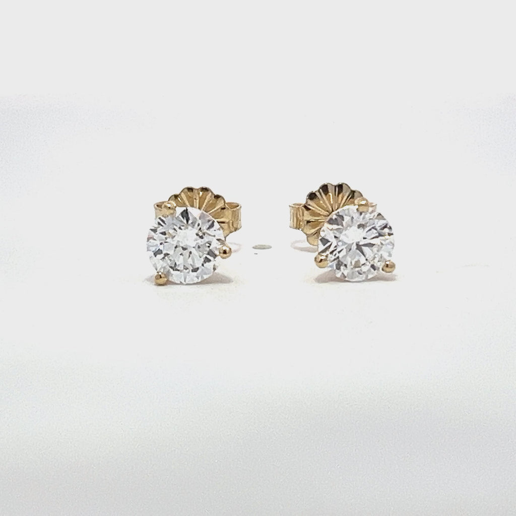 Yellow gold stud earrings with round diamonds on a white background.