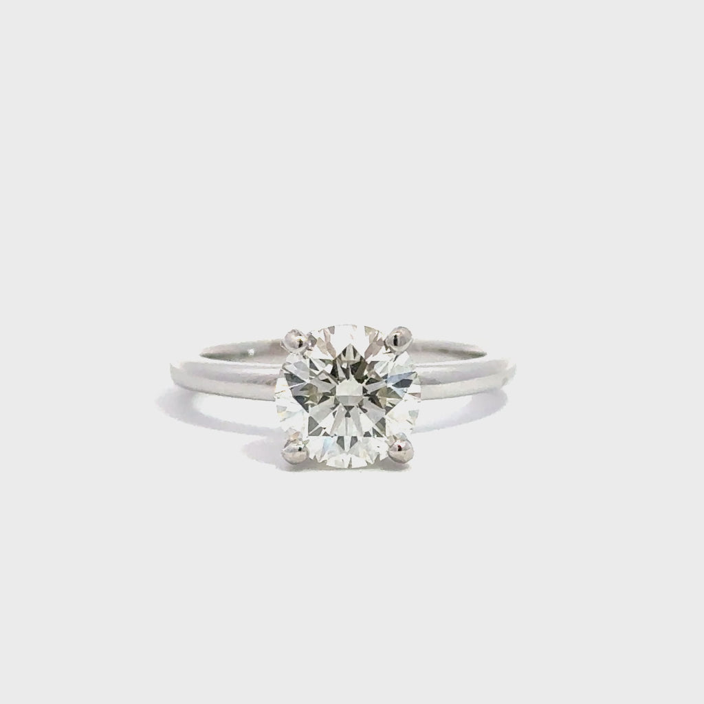 Silver solitaire ring against white background