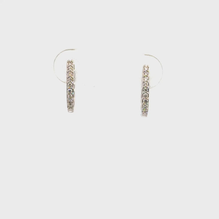 Silver hoop earrings on a white background.